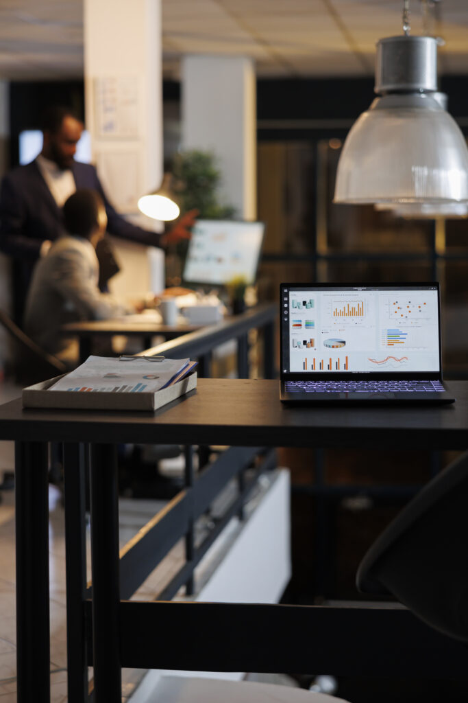 Rapport final laptop computer with financial graphs on screen
